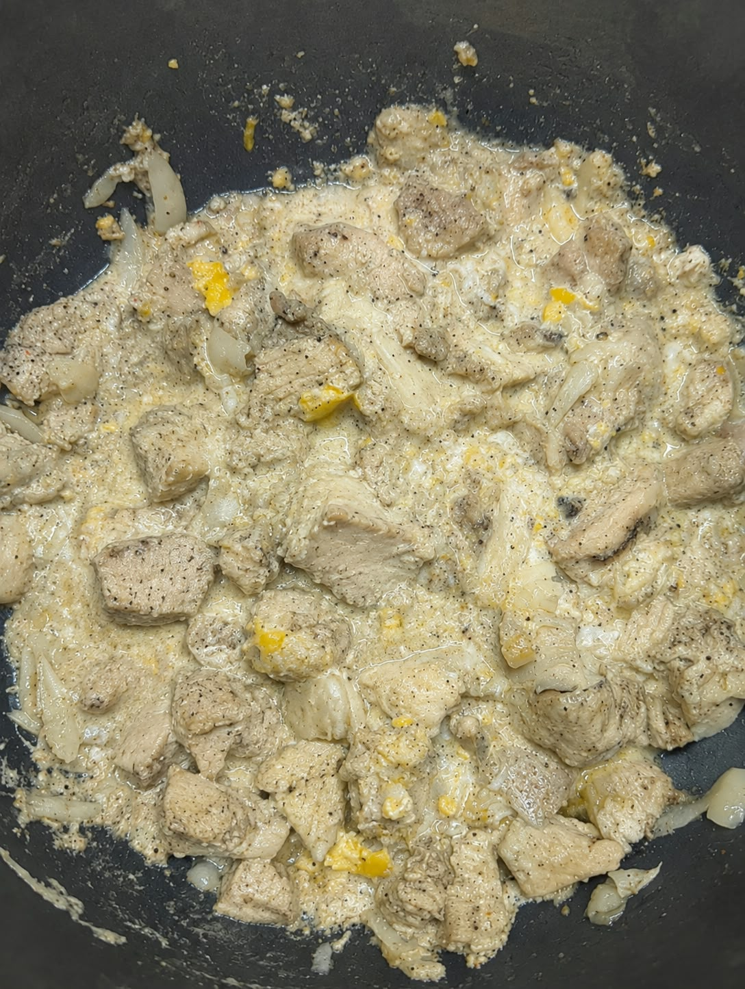A plate of chicken pasta with mixed pasta shapes and sauce