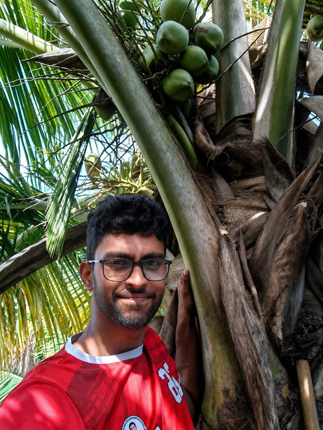 A selfie beside a coconut tree