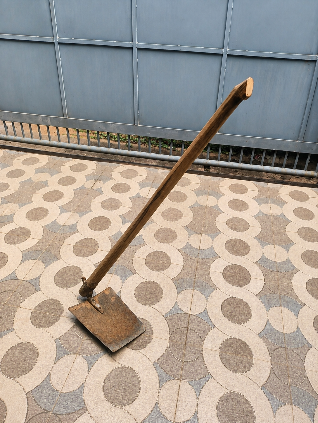 A manvetti resting on a patterned tiled floor